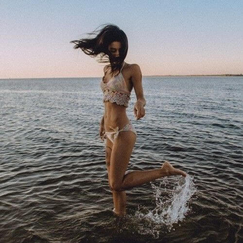 Girl standing at the sea water